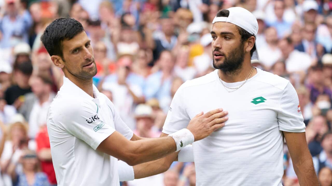 Novak Djokovic (Serbia) at the net with Matteo Berrettini (Italy) after winning the mens final on Centre Court at All England Lawn Tennis and Croquet Club