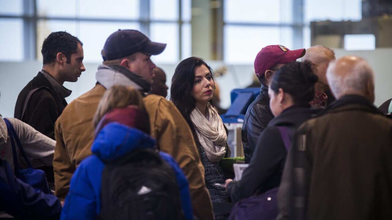 Airline travellers wait in a security line in Arlington, Virginia