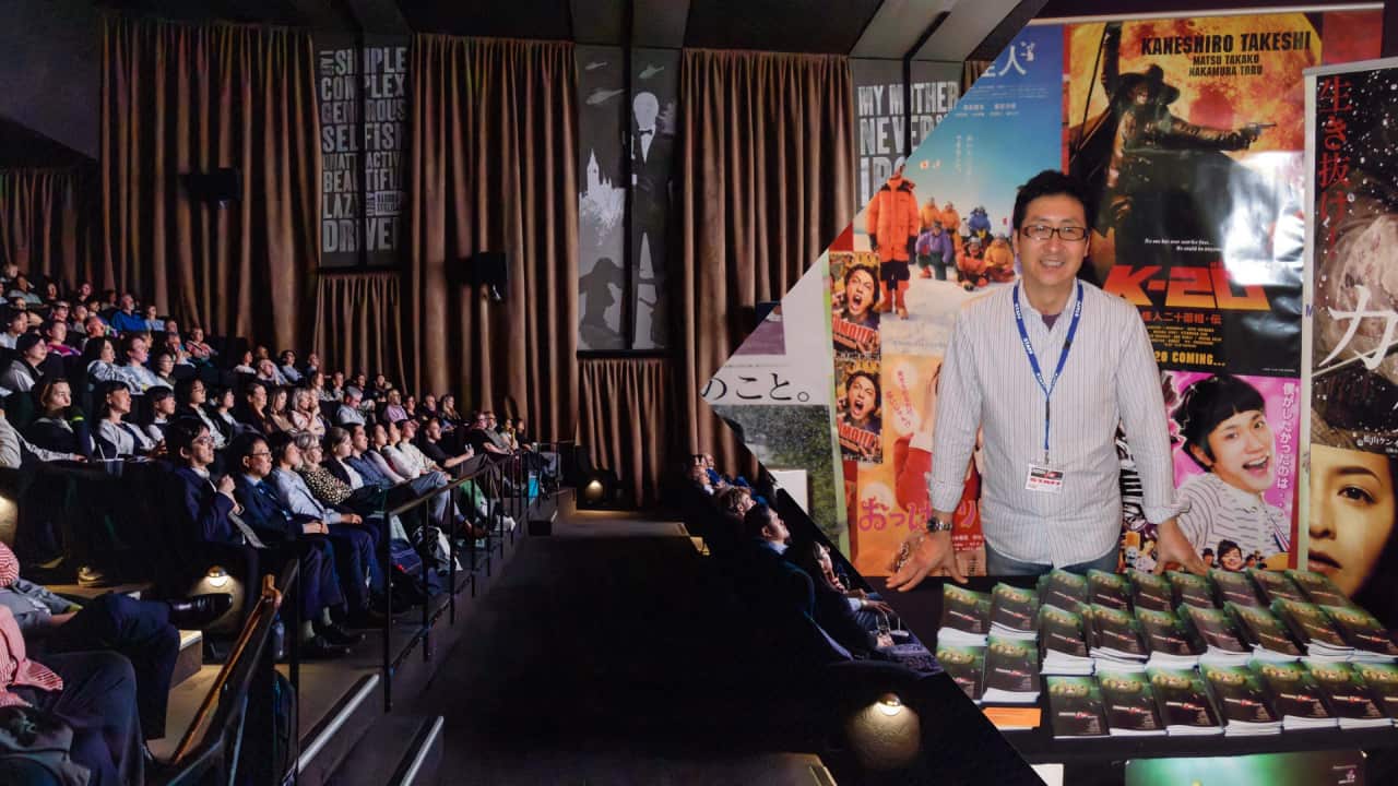 Masafumi Konomi, the founder of Japan Film Festival (JFF) , poses at a promotion booth in Sydney in 2009. JFF marked its 25th anniversary in 2021.