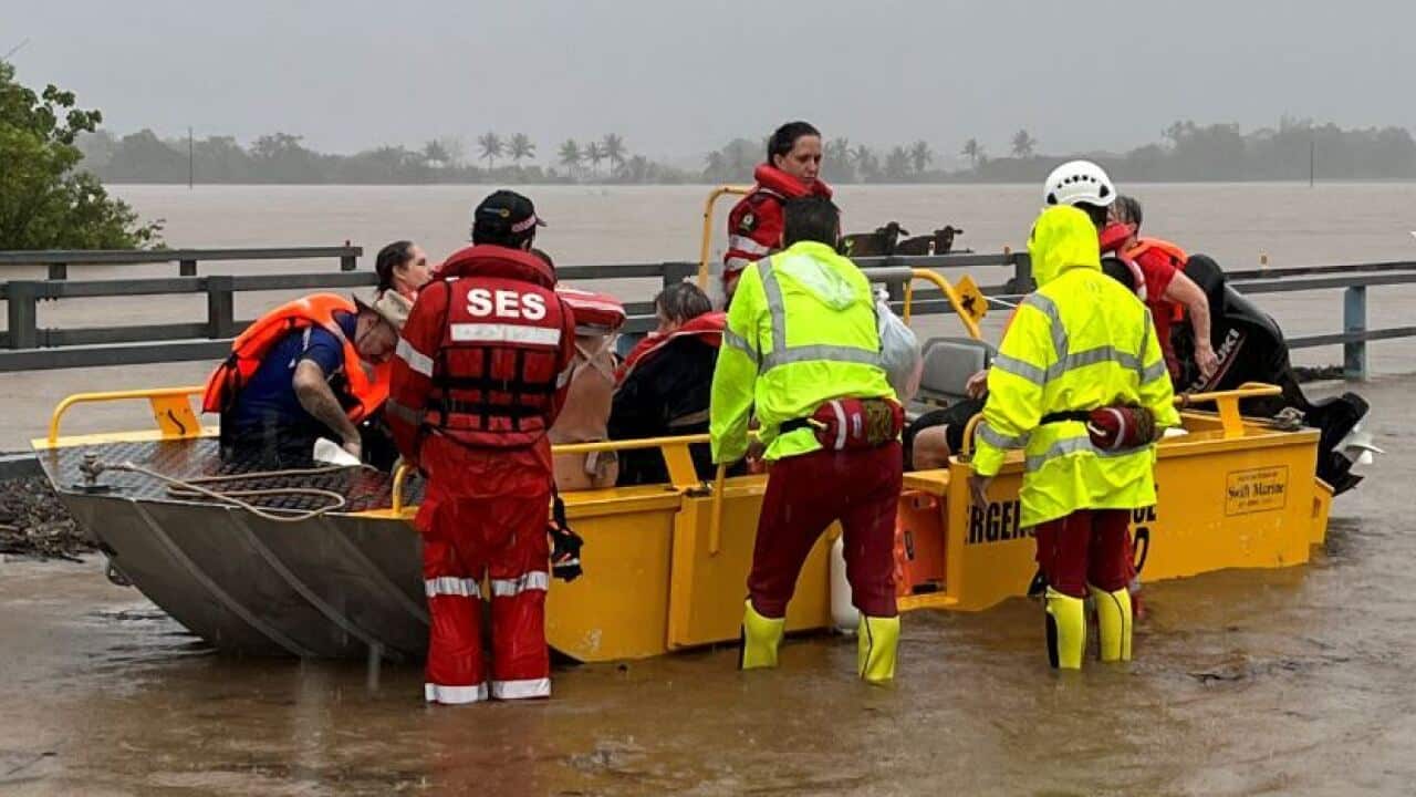 State Emergency Service personnel with a boat in flood waters in Far North Queensland