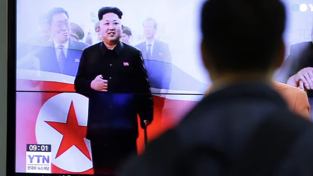 A man watches a news program showing North Korean leader Kim Jong Un
