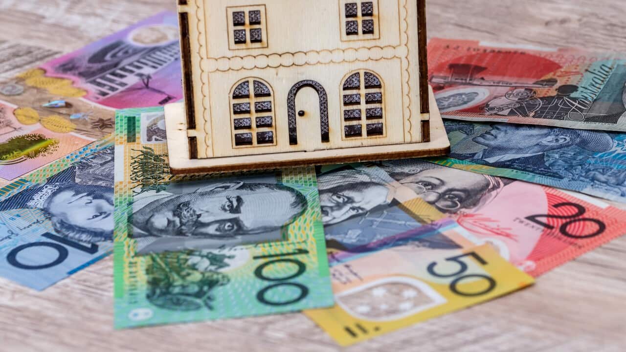 House model with australian dollar banknotes on table