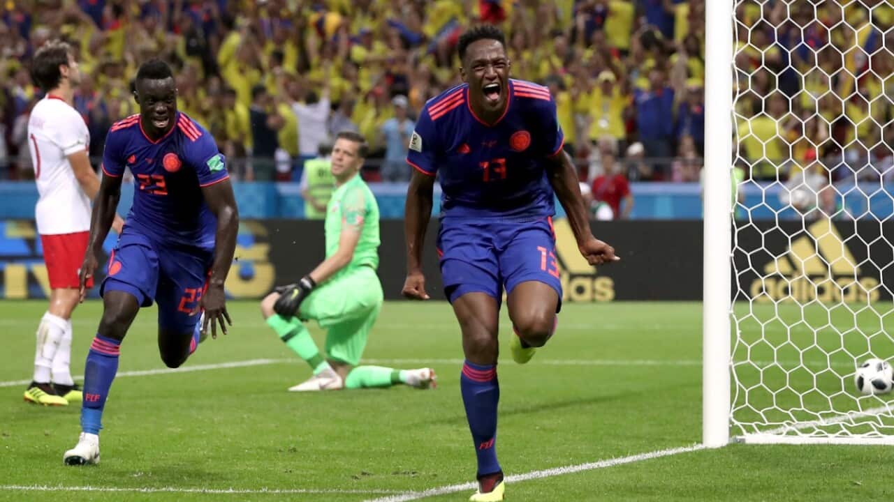 Colombia's scorer Yerry Mina, right and his teammate Davinson Sanchez, left