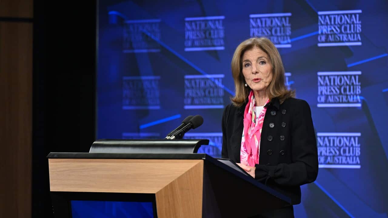 Woman speaking at a lecturn.