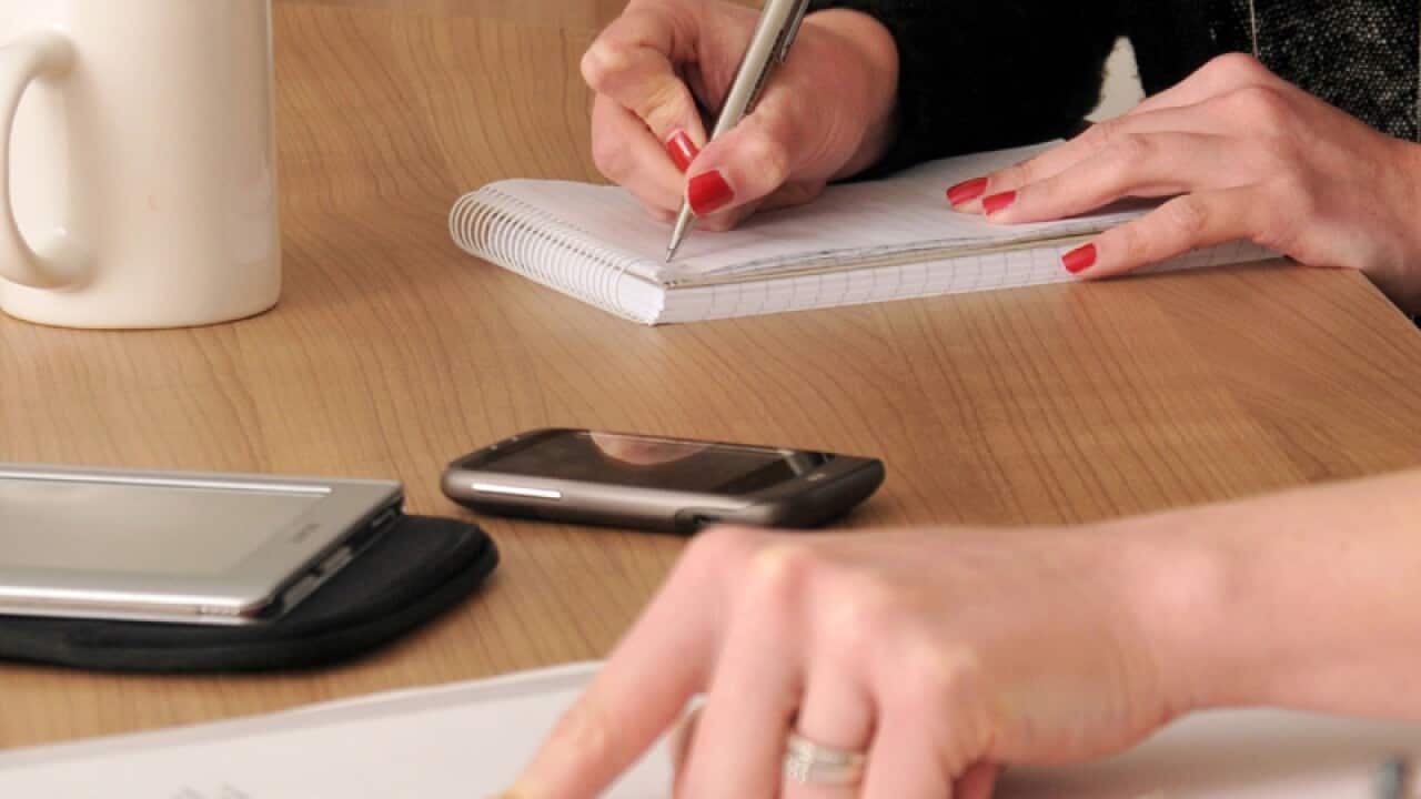 people making notes during a meeting