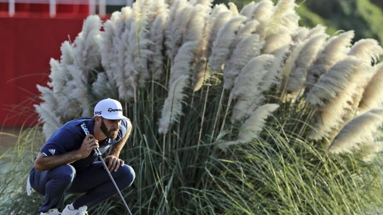 World number one golfer Dustin Johnson lines up his shot.