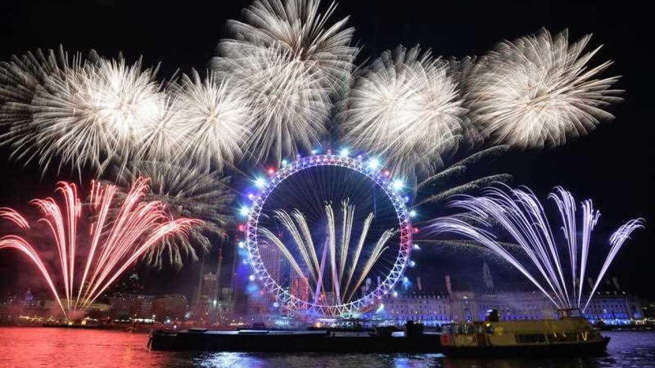 Fireworks light up the sky over the London Eye in central London during the New Year celebrations.