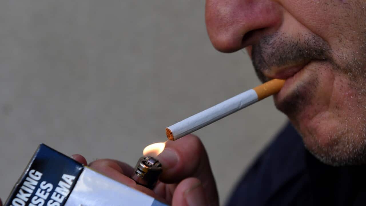 A man lights a cigarette