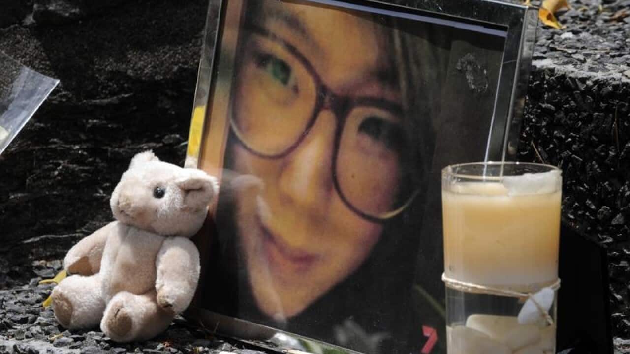 A framed photo of Eunji Ban among tributes near the murder scene
