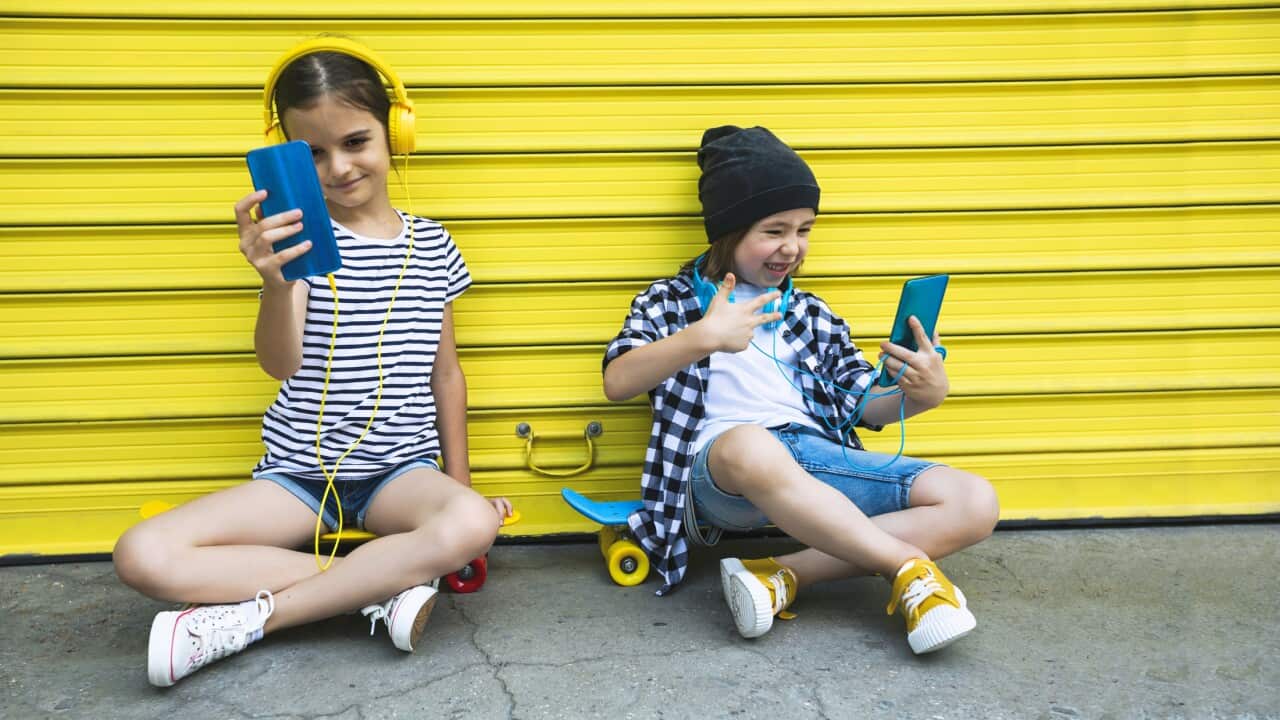 Happy children using smartphones