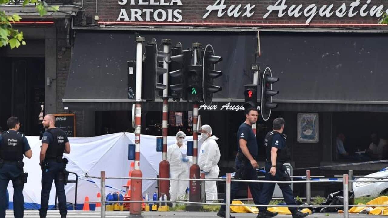 Police investigate at the scene of a shooting in Liege, Belgium.