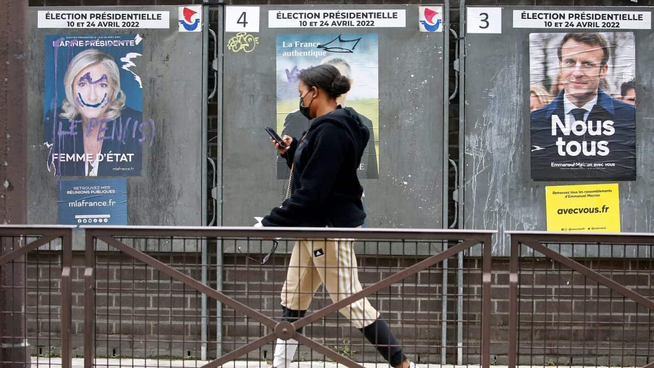 Official campaign posters of Marine Le Pen (left) and French President Emmanuel Macron in Paris