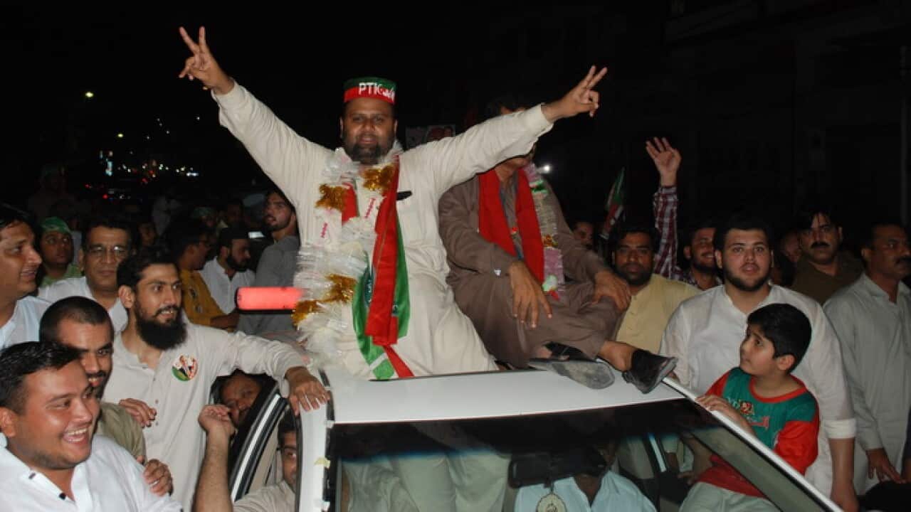 Supporters of Pakistan Tehreek-e-Insaf celebrate after election day