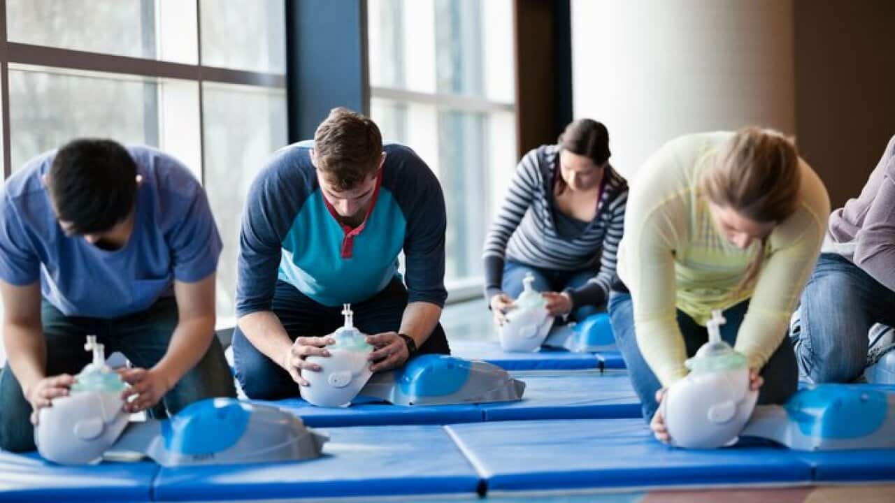 Group of people learning CPR in fitness center