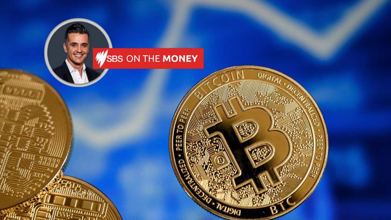 Bitcoins seen against a blue background.