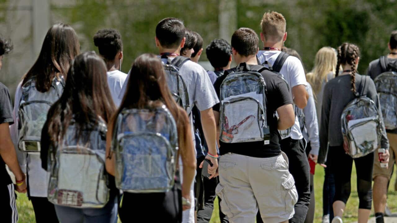 Students wear clear backpacks outside of Marjory Stoneman Douglas High School in Parkland, Florida. 