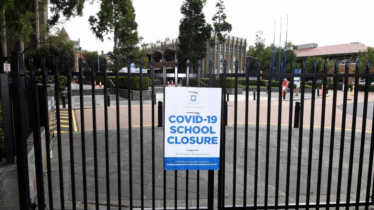 A Covid-19 closure sign on the gate of a school