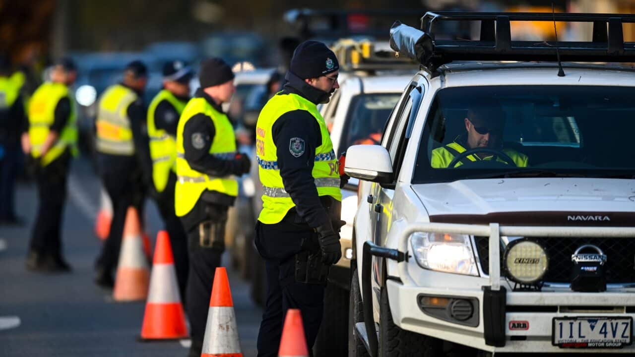 NSW Police officers check cars crossing from Victoria into New South Wales at a border check in Albury, NSW, Wednesday, July 8, 2020
