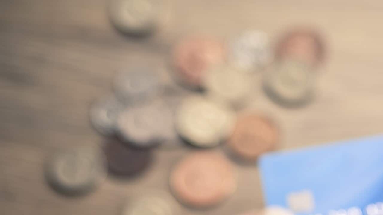 Mans hands photographing credit card using smartphone