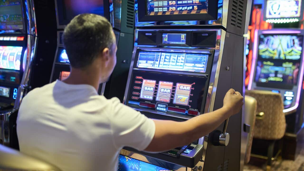 Man Playing Slot Machine