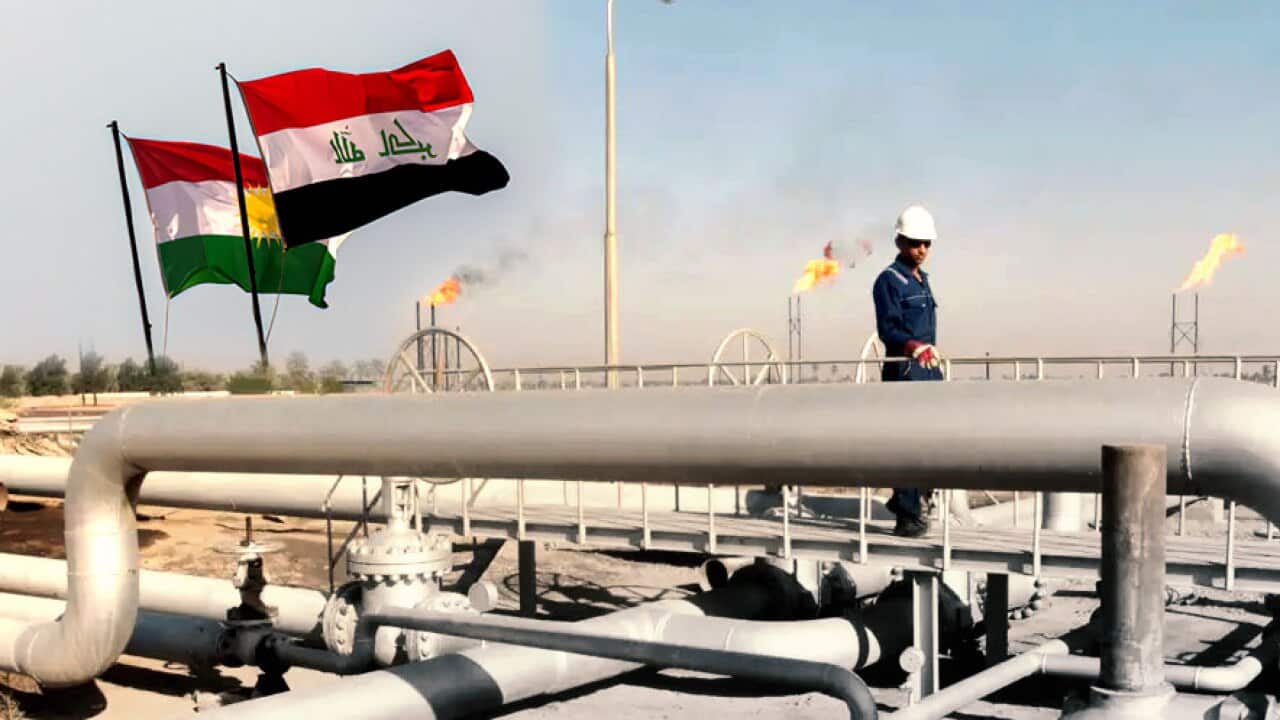 Kurdish and Iraqi flags flying over Oil pipes.jpg