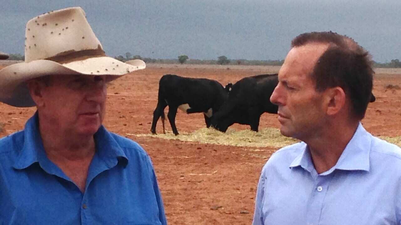 Prime Minister Tony Abbott (R) speaks with farmer Phil Ridge Sunday, Feb.16, 2014. Mr Abbott meet with local farmers while touring drought effected farms near Bourke NSW. (AAP IMAGE/ PAUL OSBORNE). NO ARCHIVING