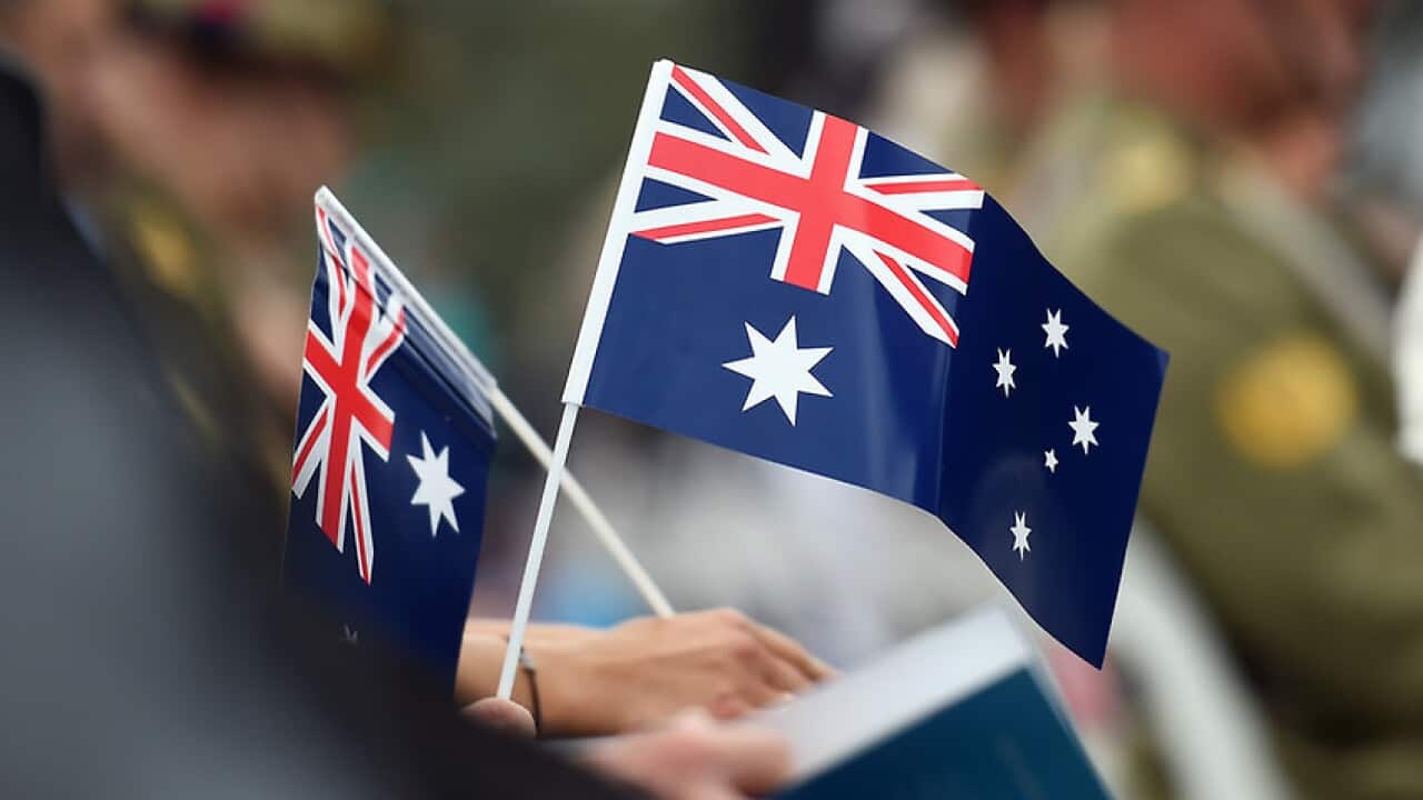 Memmbers of the public hold flags at an Australia Day Citizenship Ceremony and Flag Raising event in Canberra on Tuesday, Jan. 26, 2016. (AAP Image/Mick Tsikas) NO ARCHIVING