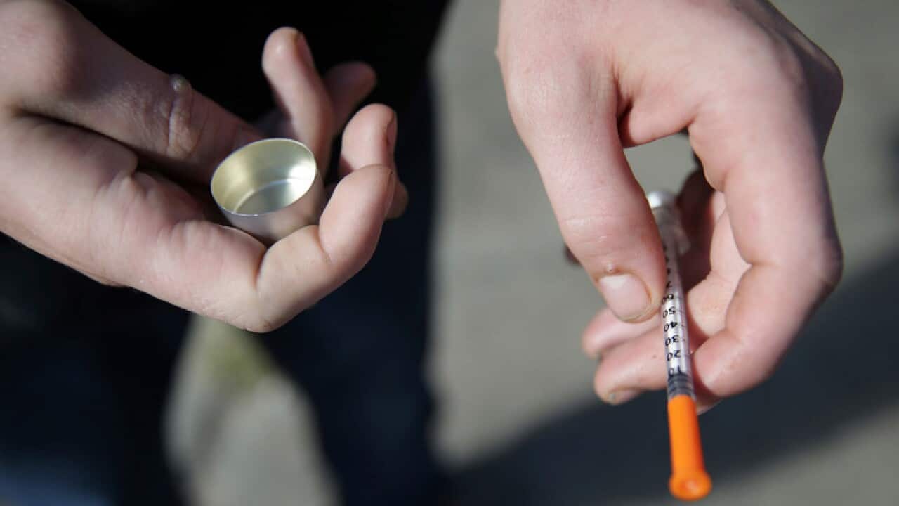 A fentanyl user who didnt want to be identified holds a needle near Kensington and Cambria in Philadelphia, 