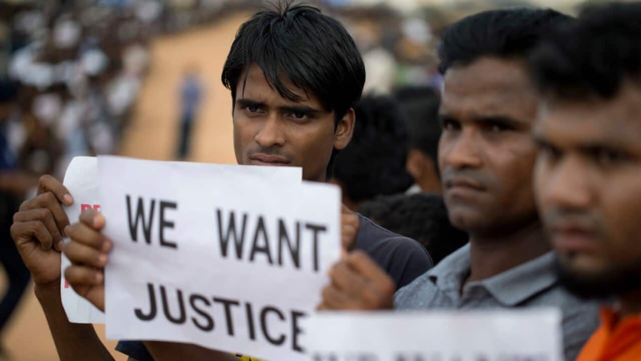 Rohingya refugees holing placards, await the arrival of a U.N. Security Council team at the Kutupalong Rohingya refugee camp