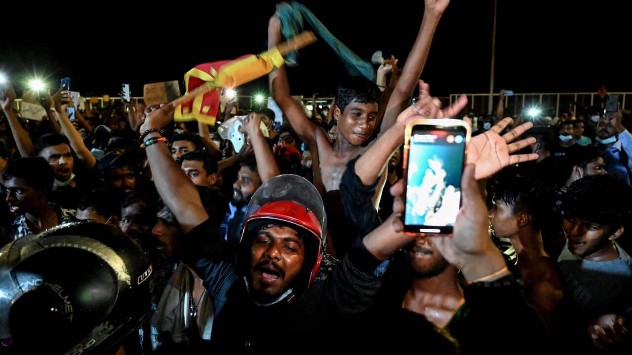 Sri Lankans are seen taking part in a protest.