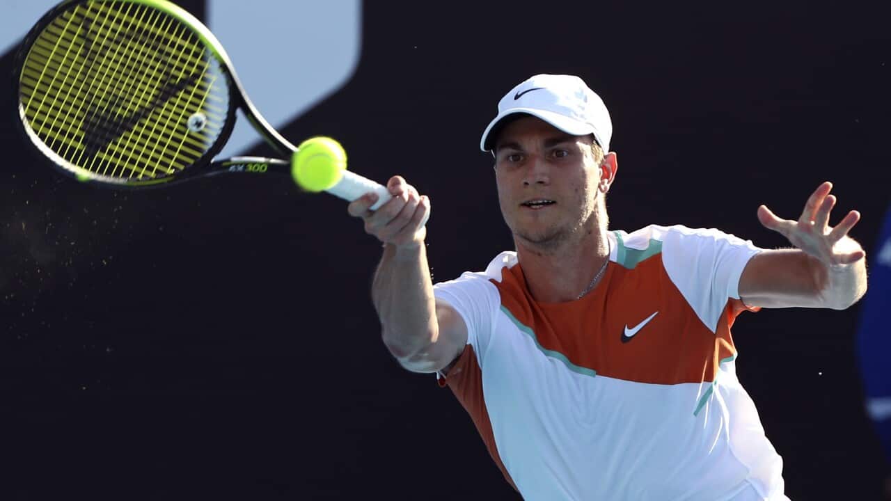 Miomir Kecmanovic of Serbia plays a forehand return to Salvatore Caruso of Italy during their first round match at the Australian Open tennis championships in Melbourne, Australia, Monday, Jan. 17, 2022. (AP Photo/Tertius Pickard)