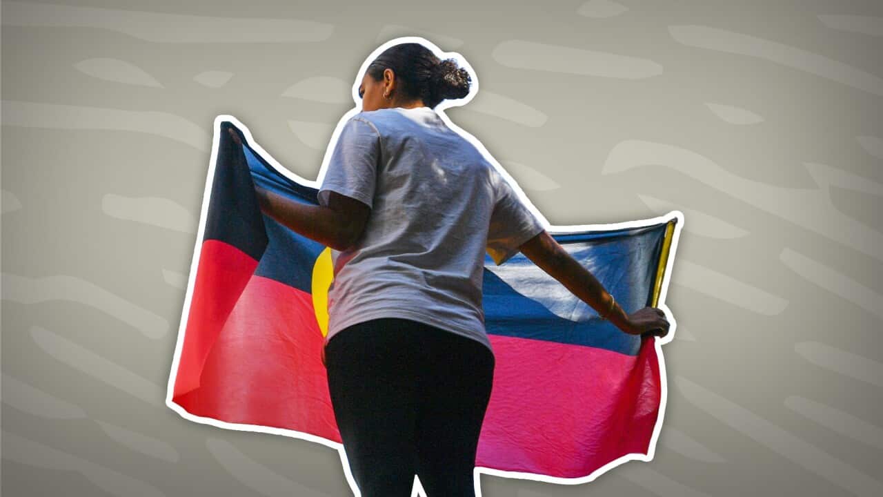 Indigenous woman with the Aboriginal flag (SBS).jpg