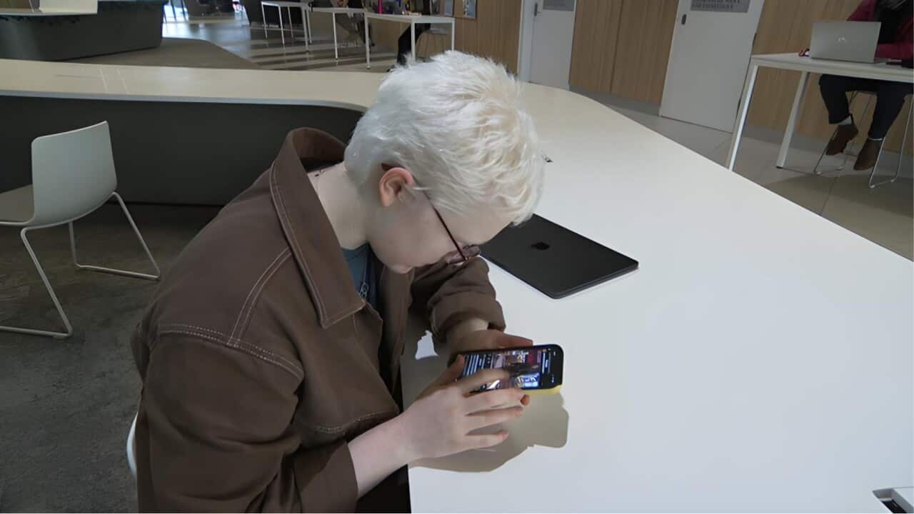 Zara Perry using audio description to access social media (SBS).jpg
