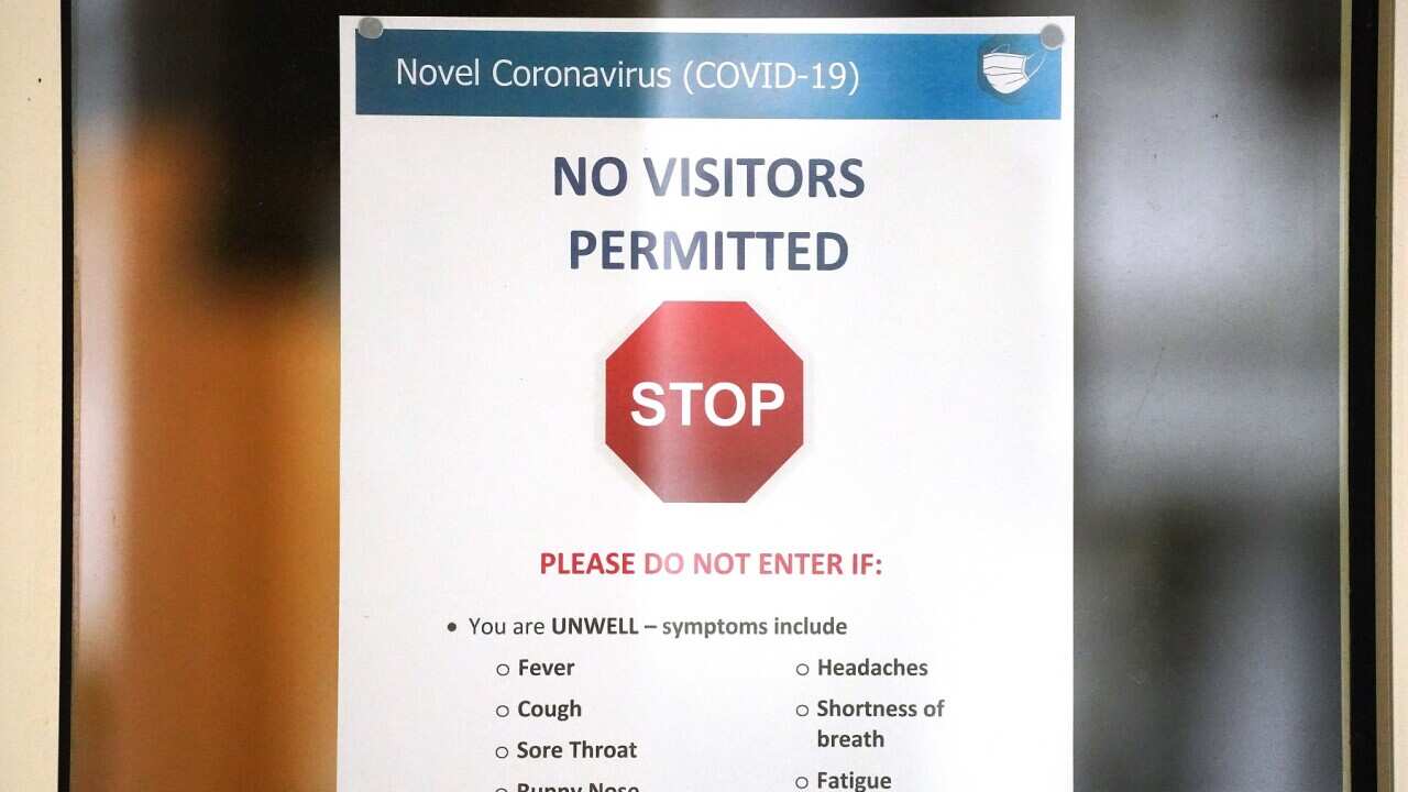A sign is seen on the window of the Albert Road Clinic in Melbourne