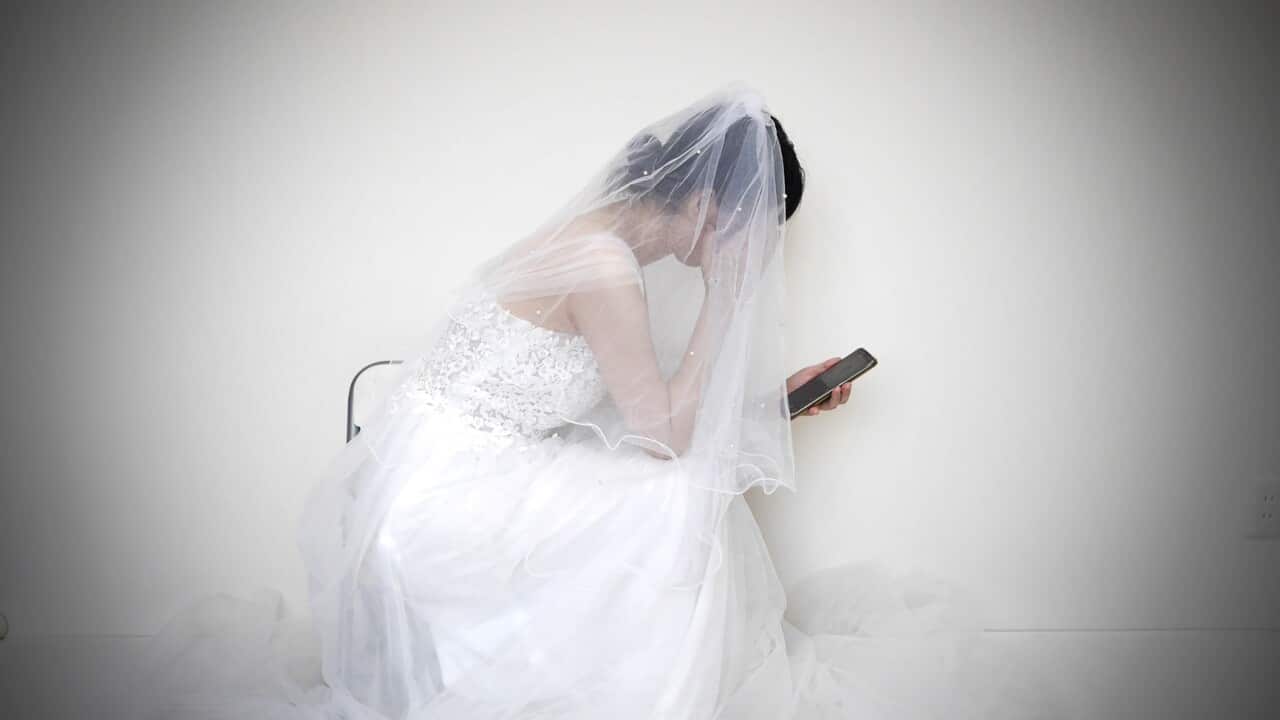 Depressed woman using mobile phone