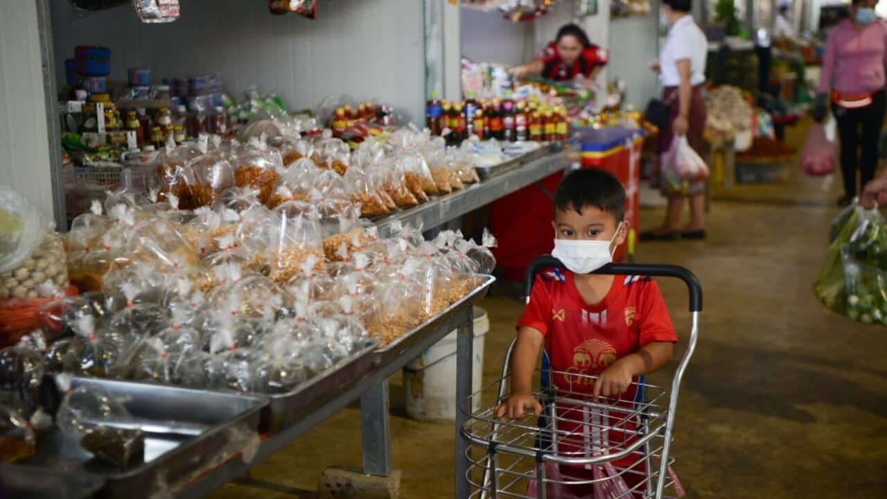 LAOS-VIENTIANE-COVID-19-LOCKDOWN. A masked child pushes a shopping cart in a market in Lao capital Vientiane on Aug. 4, 2021 (Kaikeo Saiyasane-Xinhua via Getty Images)