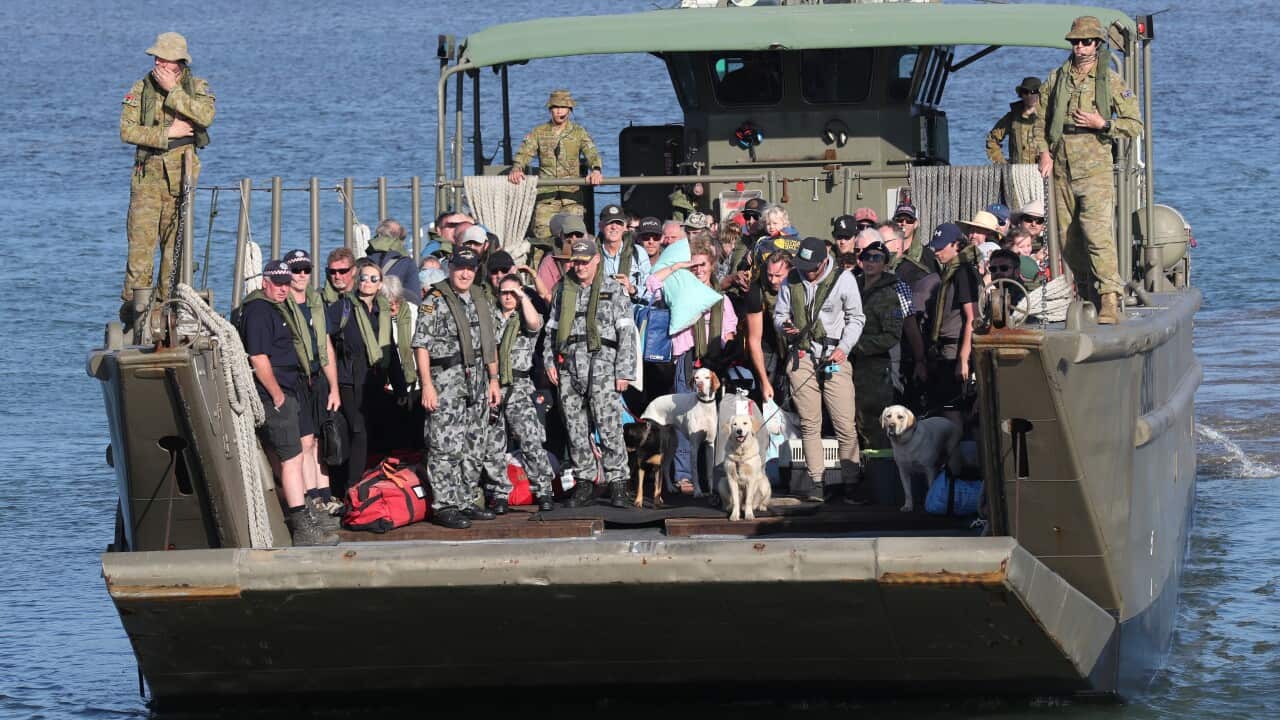 Evacuees disembarks the HMAS Choules in Hastings, Victoria, on board landing boats after fleeing bushfires.