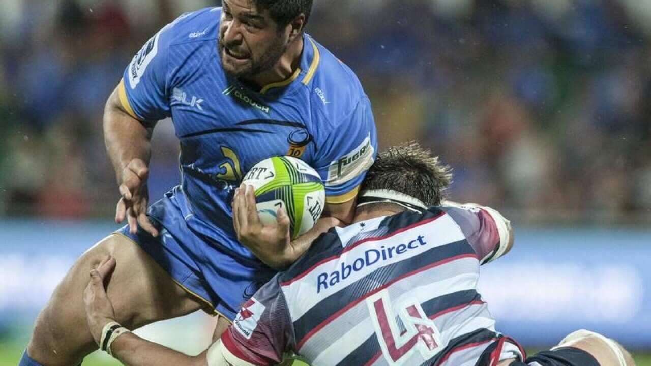 Pek Cowan of the Western Force is tackled.
