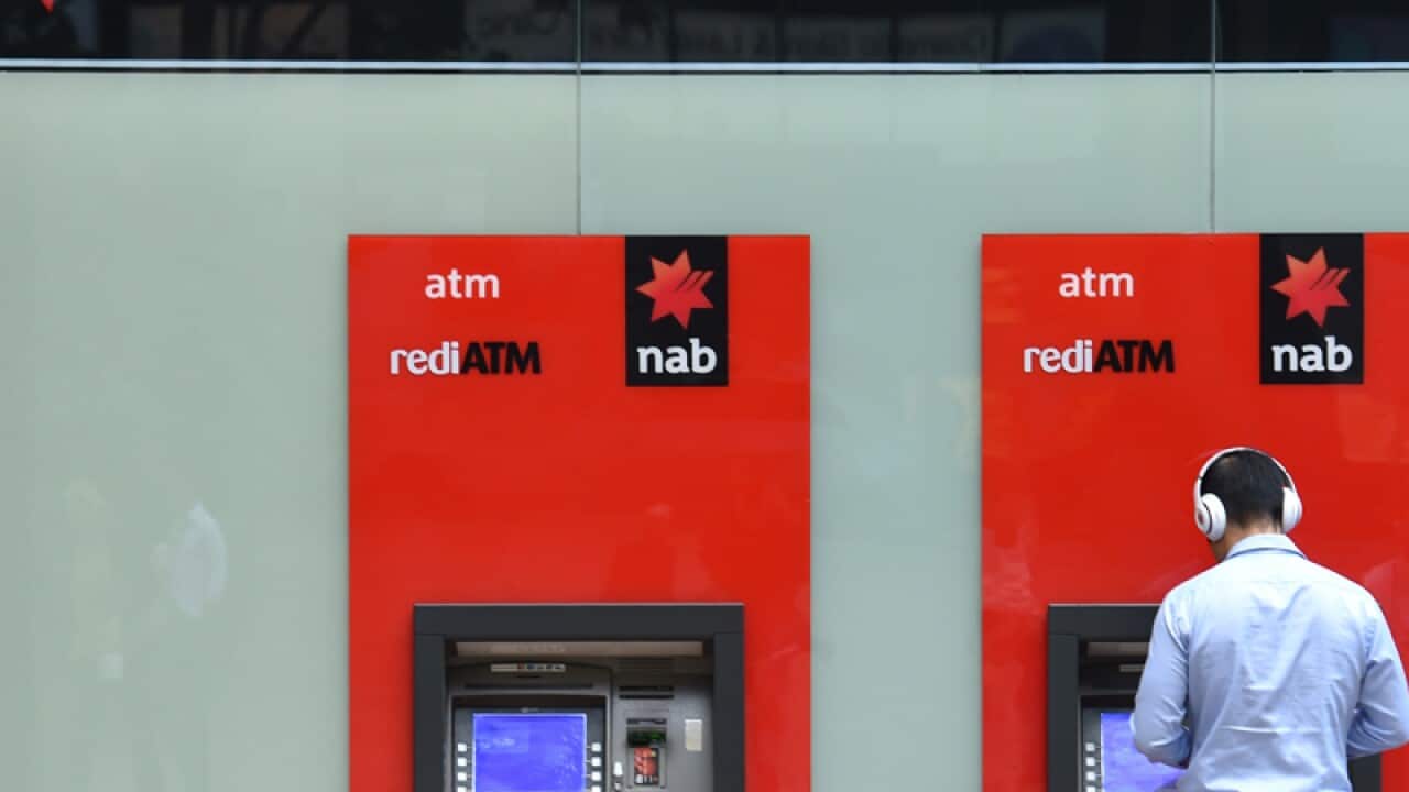 A man uses a NAB ATM