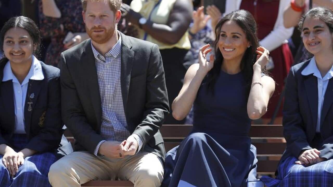 Prince Harry and Meghan with two students from Macarthur Girls' High.