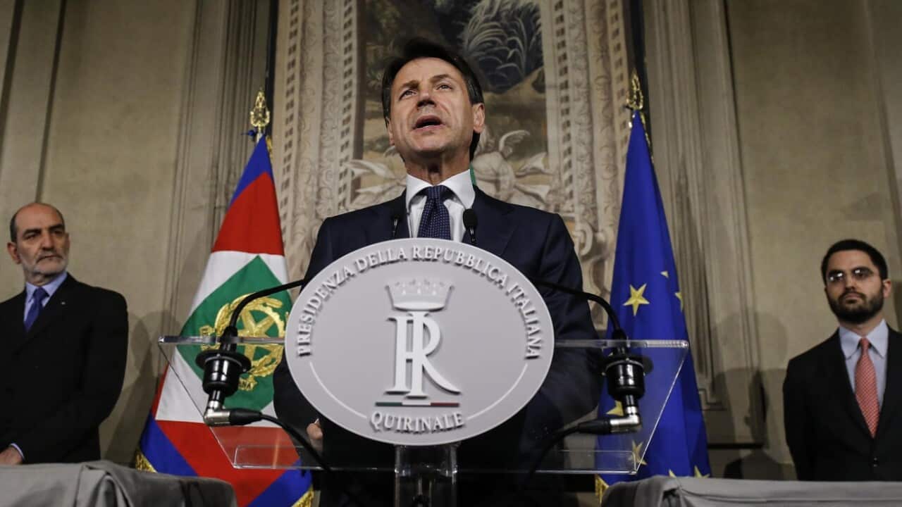 Italian Prime Minister-designate Giuseppe Conte (R) addresses the media to announce his list of ministers