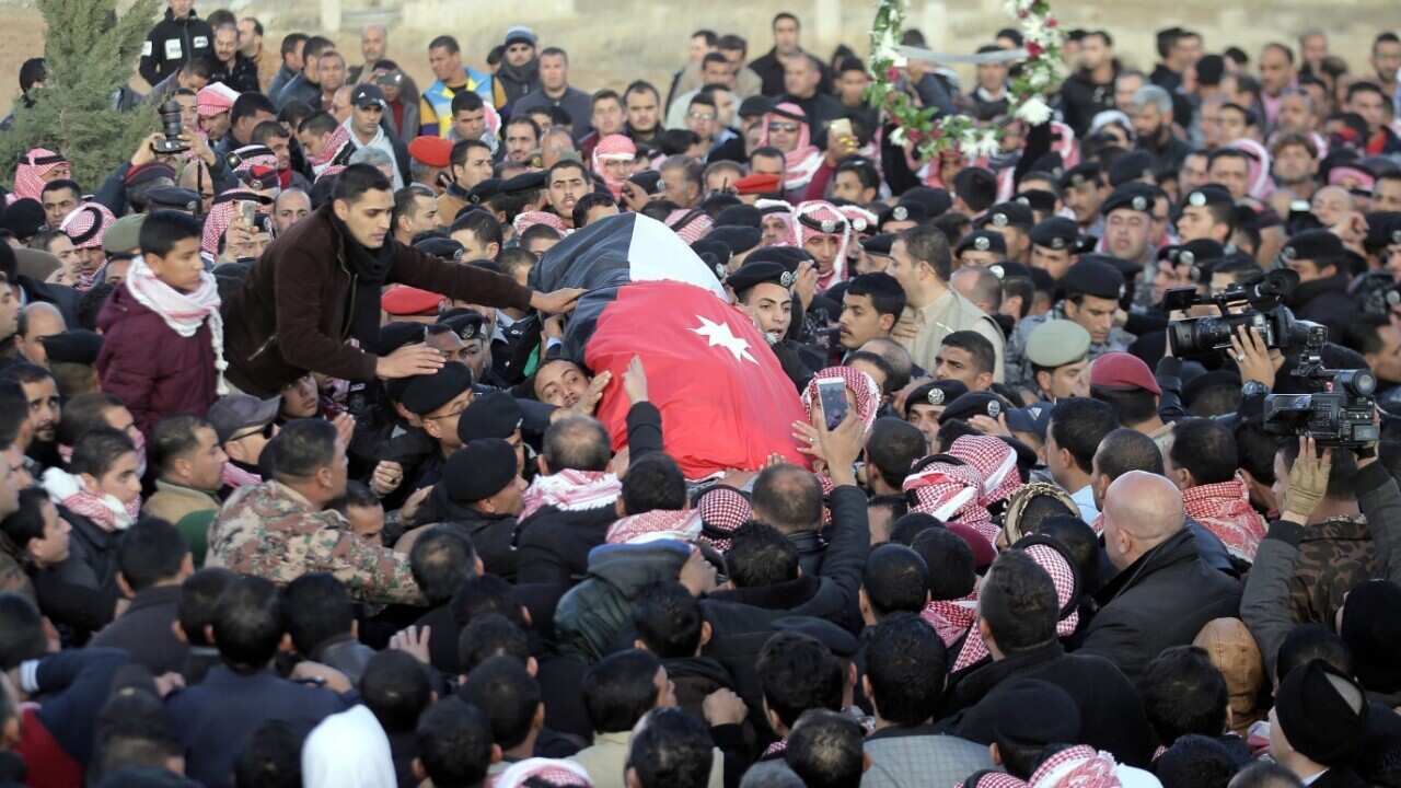 Jordanian mourners carry the coffin of Police Major Lieutenant Saed Mayateh