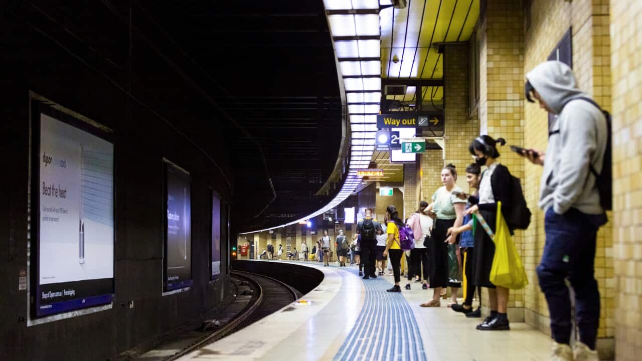 People waiting for train in subway station, background with copy space