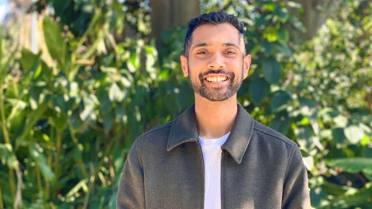 A man standing outside smiling at a camera.