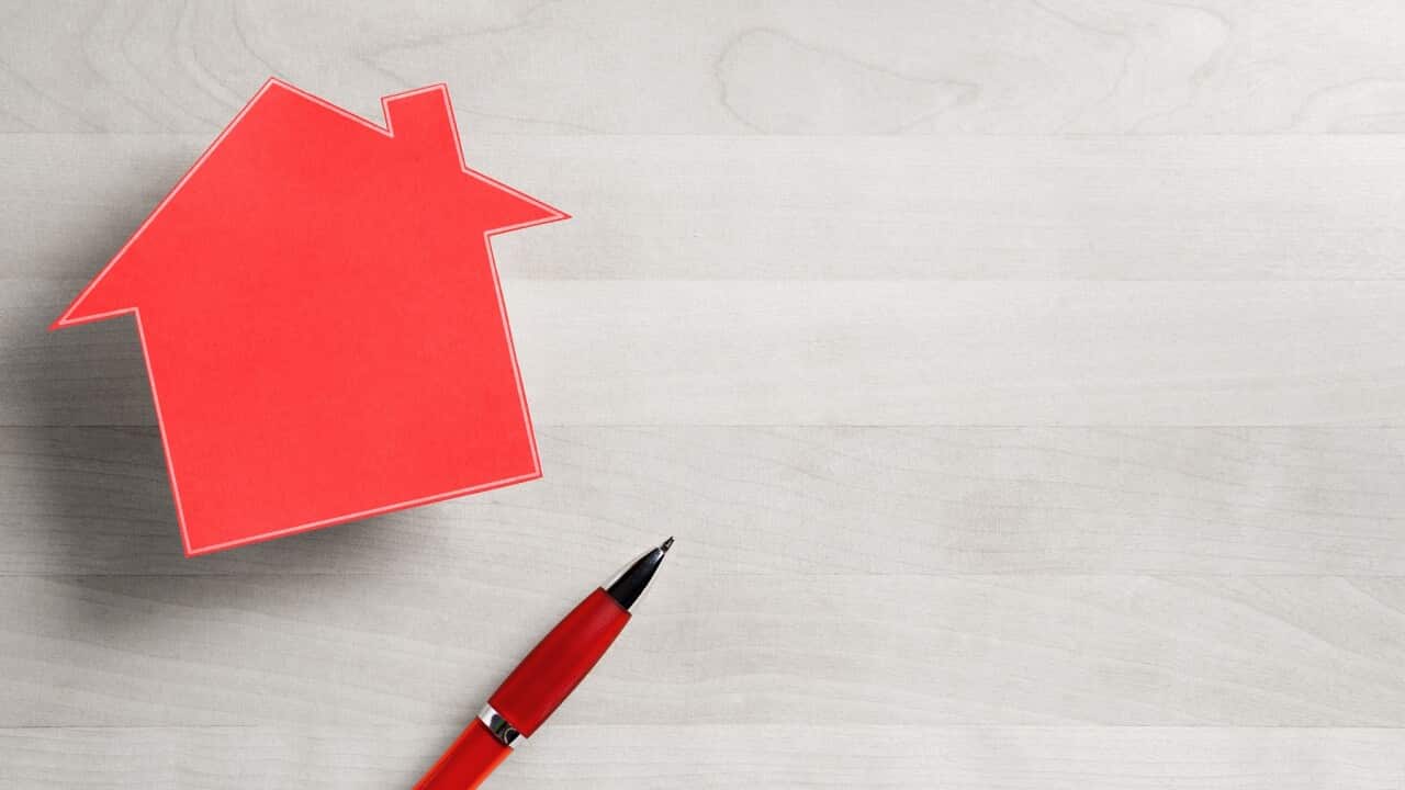 Real estate business. House for sale. Cottage made from cardboard paper on wooden table. House warming party template. Selling and buying home. Empty blank negative copy space.