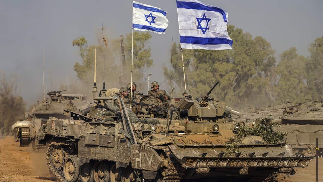 Israeli army vehicles arrive to an staging area after combat in the Gaza Strip.