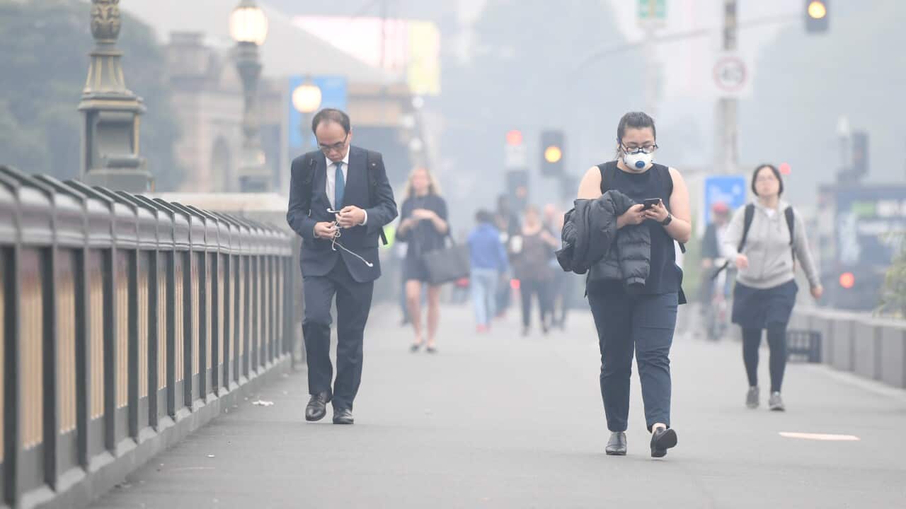 Morning commuters are seen through smoke haze from bushfires in Melbourne, Tuesday, 14 January, 2020. 