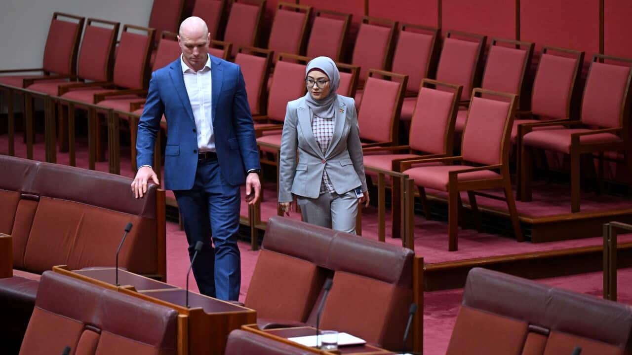 Labor Senator Fatima Payman walks with Independent Senator David Pocock as she crosses the floor at Parliament House.