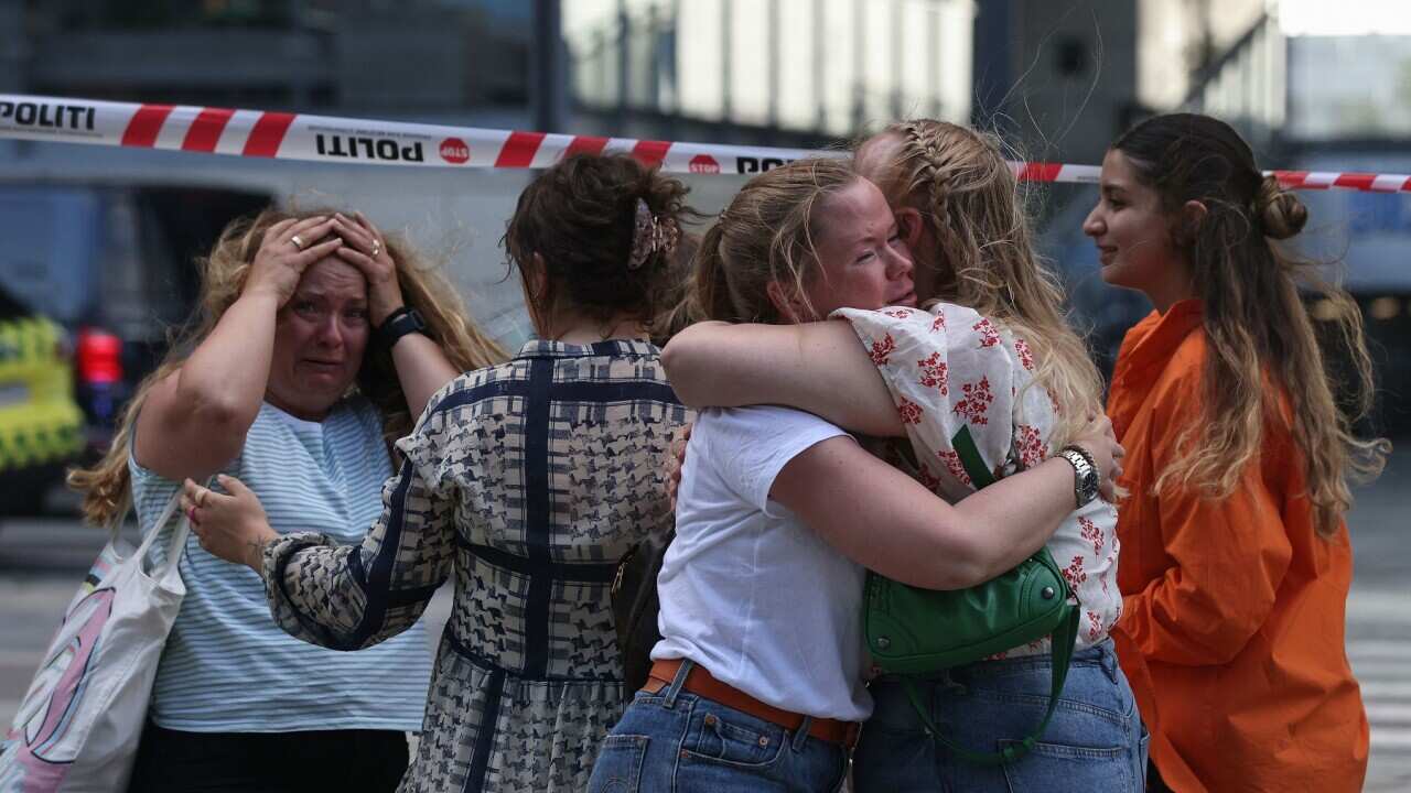People embrace after shooting In Copenhagen