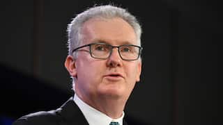 A close frame of grey-haired, Home Affairs Minister Tony Burke, mid-speech.